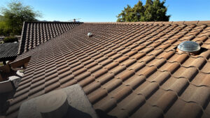 A brown roof with trees in the background